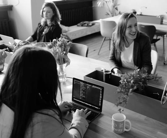 iamge showing a group of women working at a workplace